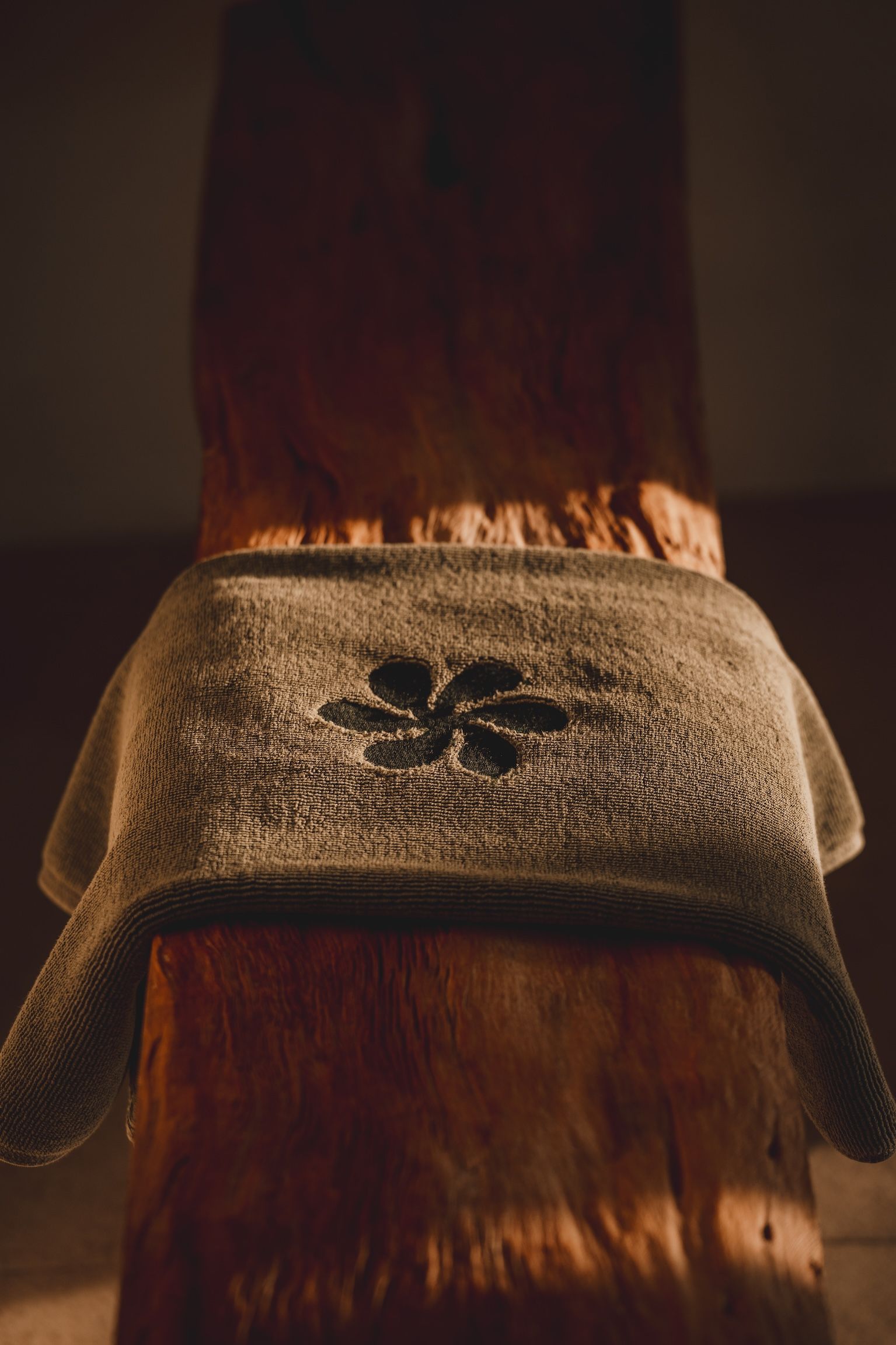Cozy beige knit slipper warming by a fire, with flames visible behind it