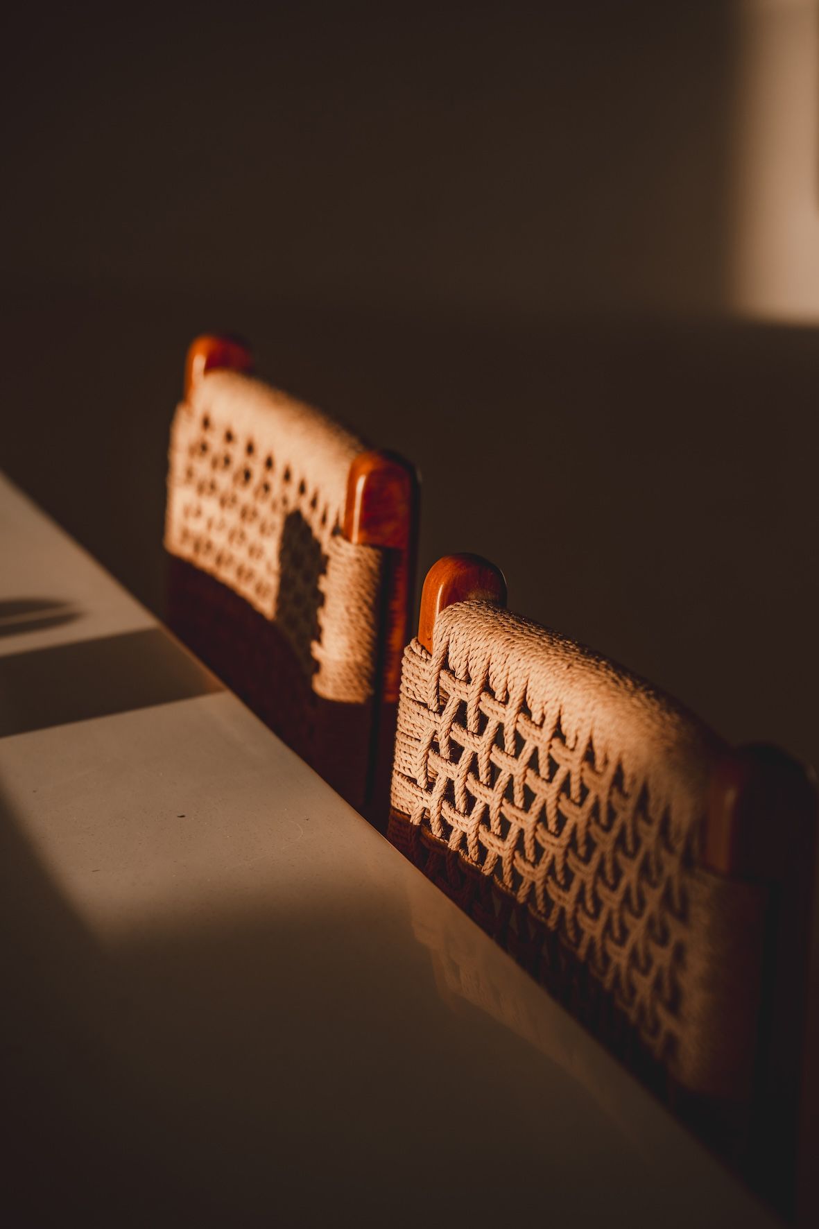 Two small woven baskets in warm sunlight on a table