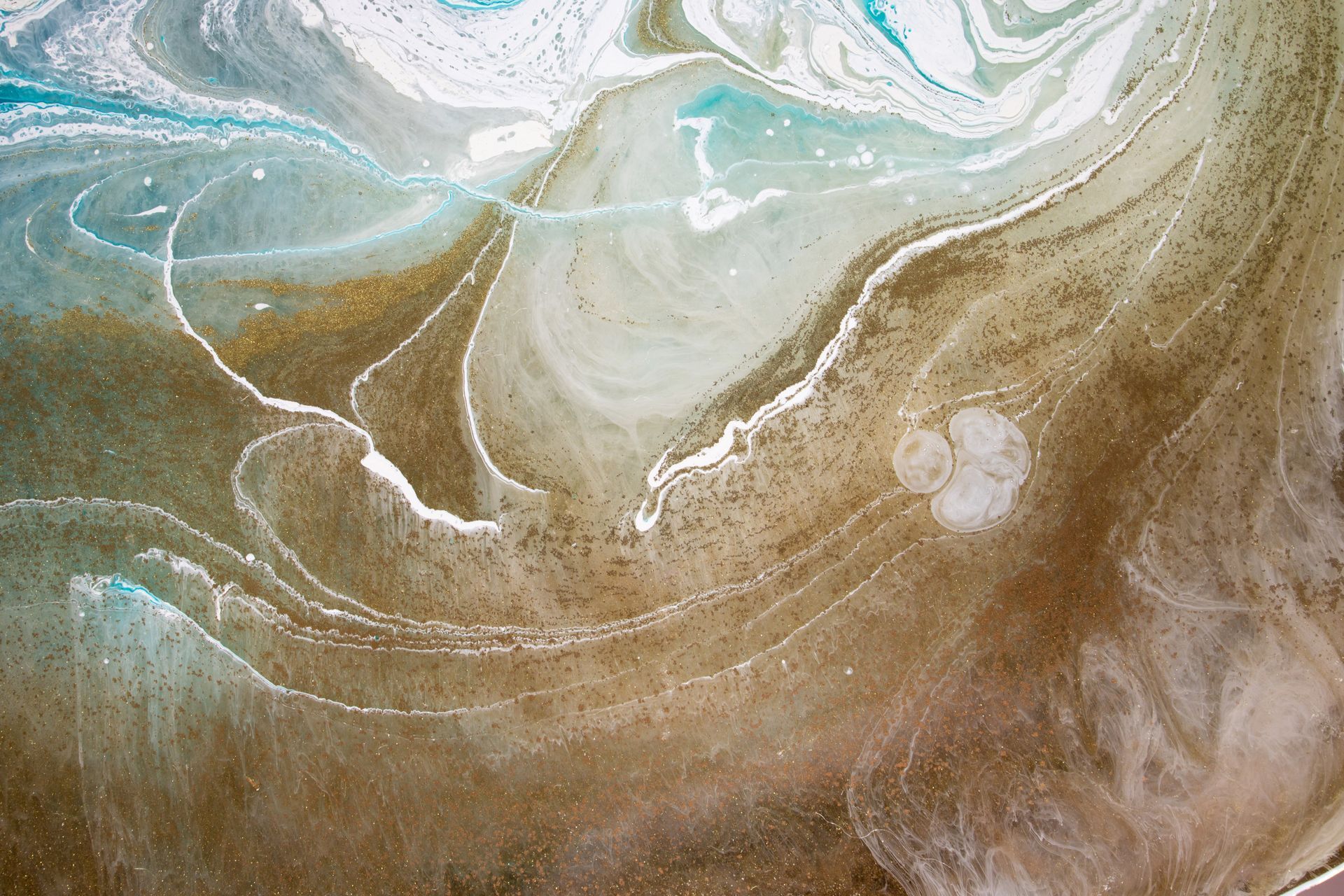 Abstract artwork of swirling resin in shades of blue, white, and tan. Abstract artwork of swirling resin in shades of blue, white, and tan.