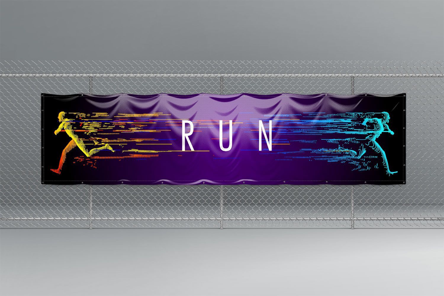 A PVC banner that says run is hanging on a chain link fence.