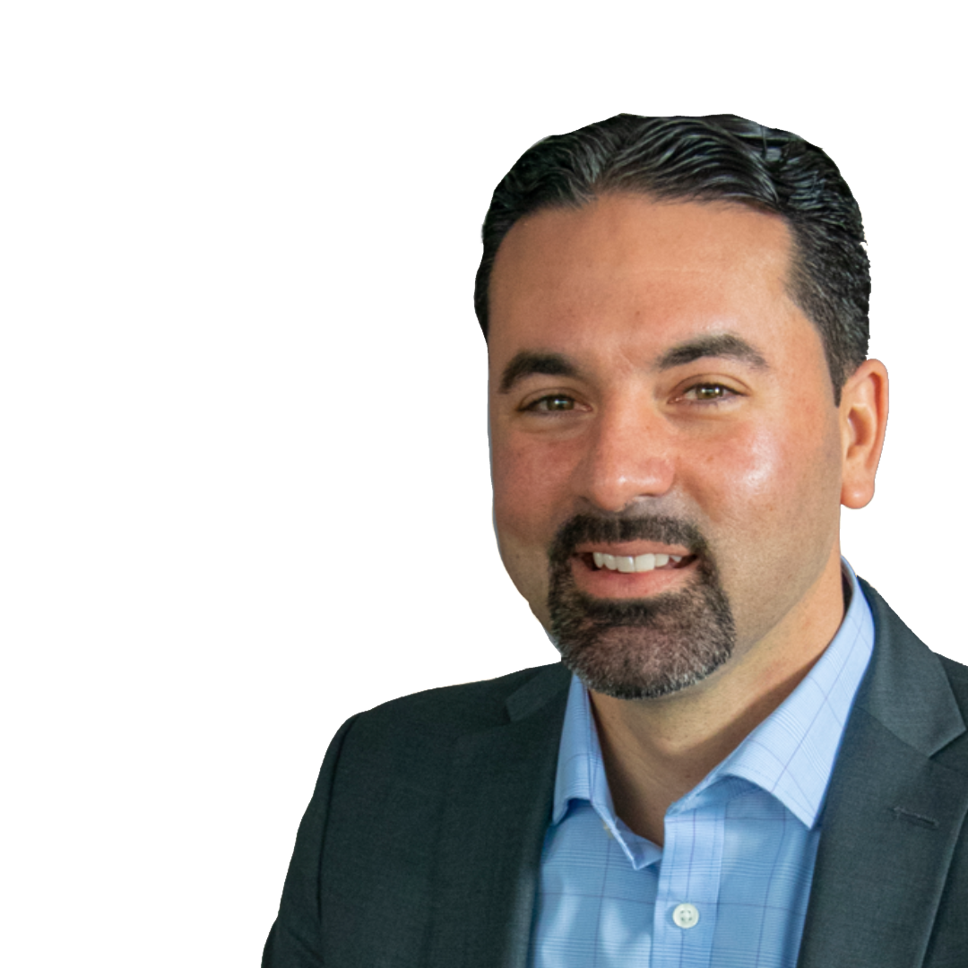 A man with a beard is wearing a suit and smiling