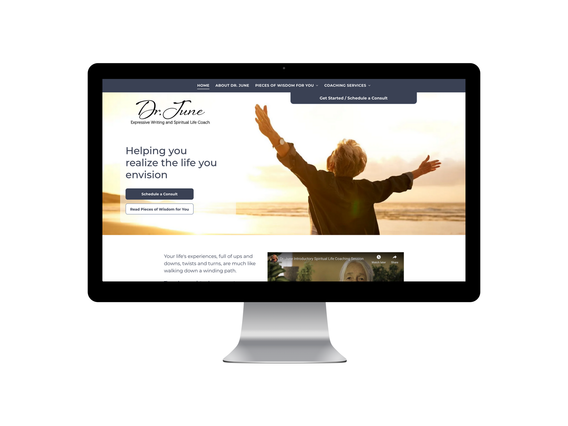 Desktop computer displaying a website. The website features a person with raised arms on a beach at sunset.