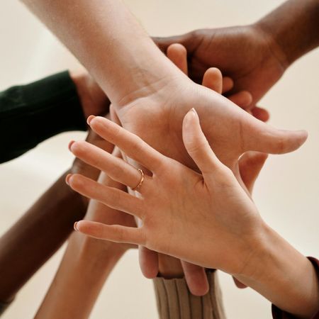 Hands of all colors linked together