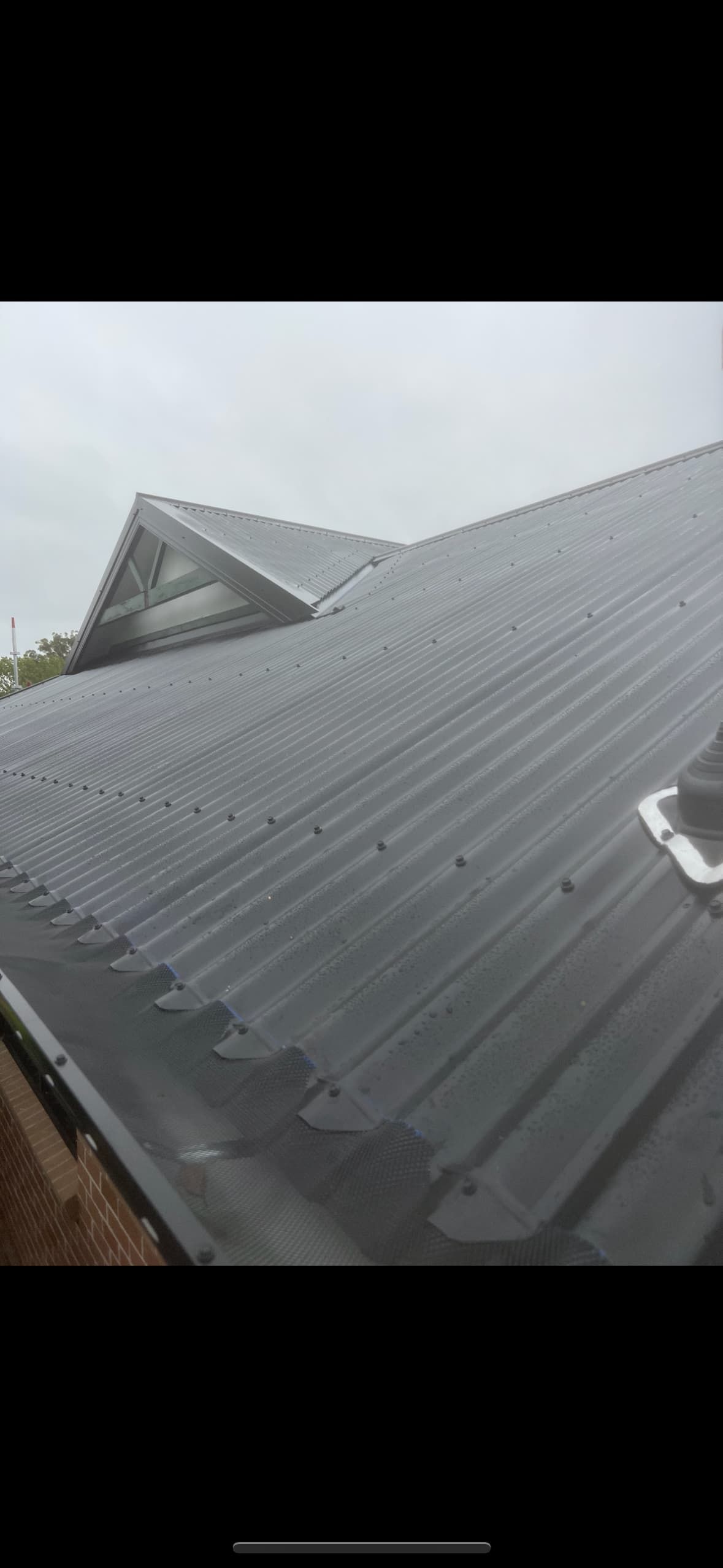 A Close Up of a Roof With Rain Drops on It — DC Roofing In Leichhardt, NSW