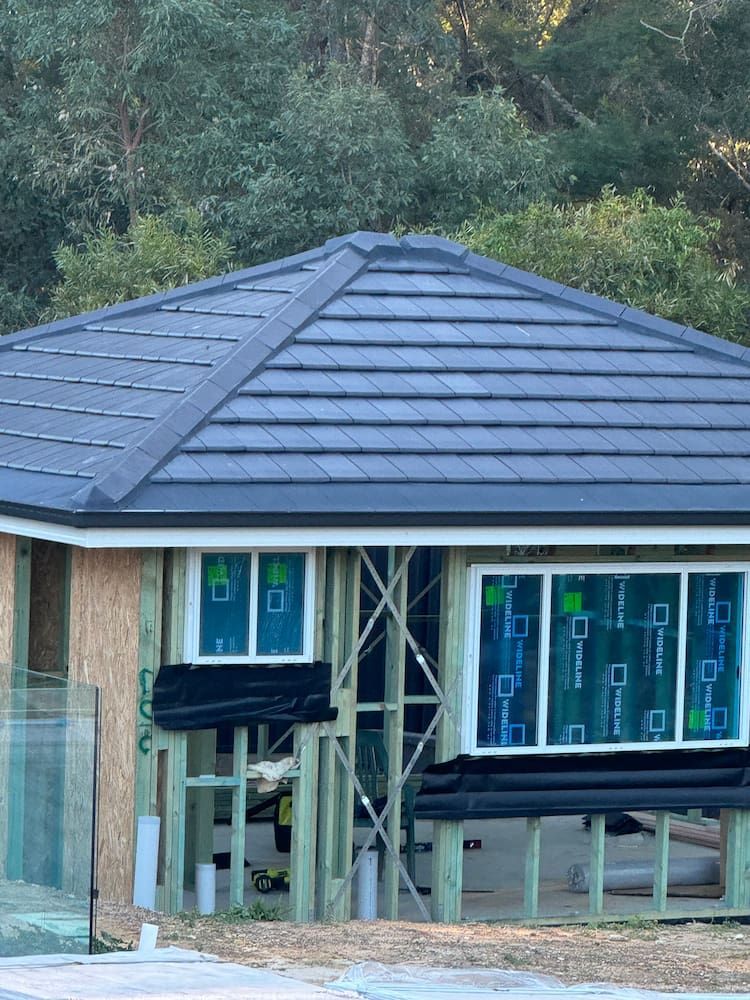 A House That is Being Built With a Blue Roof — DC Roofing In Marsden Park, NSW