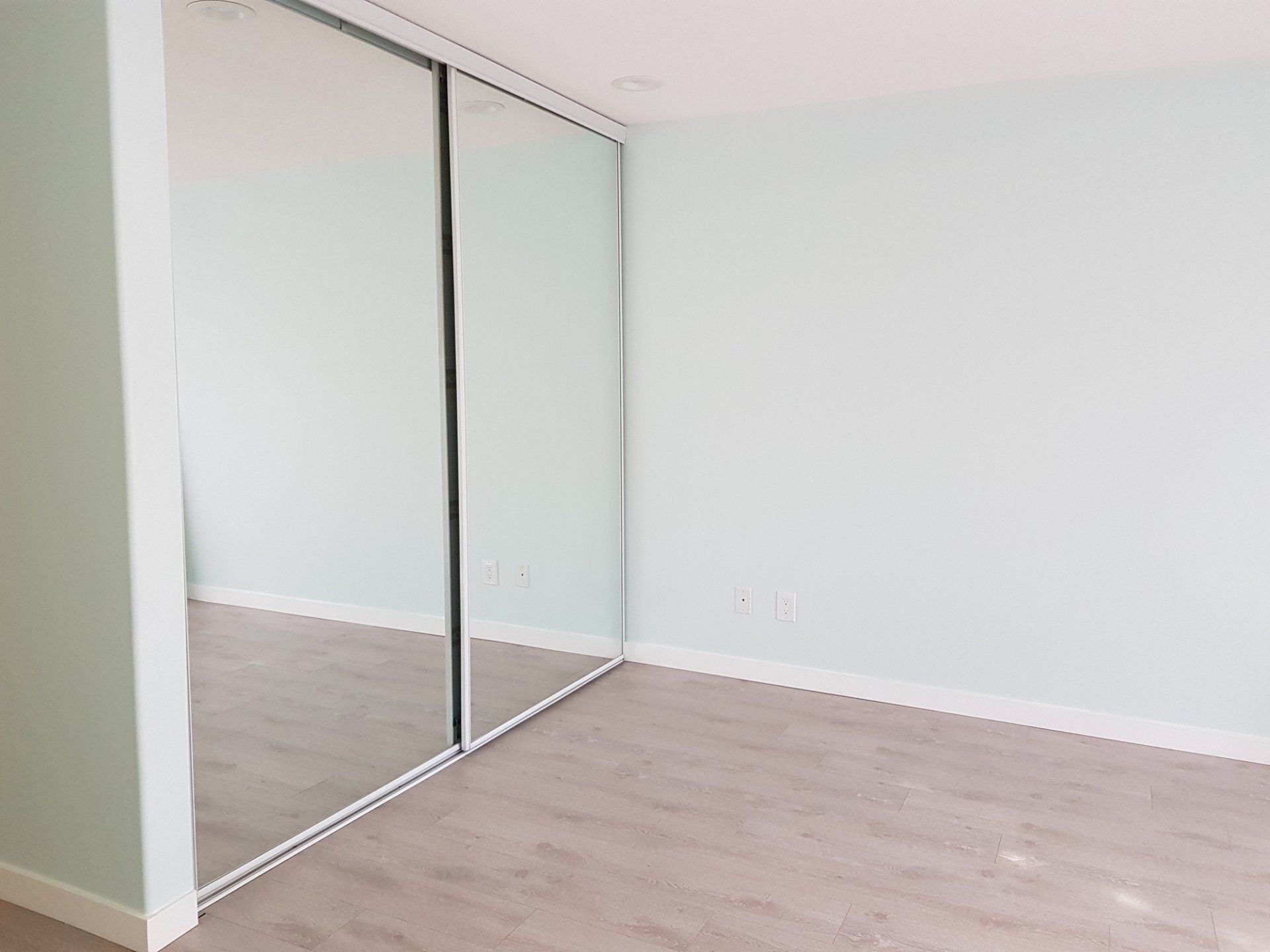 Modern Wooden Wardrobe with Glass Doors and Fashionable Lighting — North Geelong — Geelong Glass & Aluminium Pty Ltd Modern Wooden Wardrobe with Glass Doors and Fashionable Lighting — North Geelong — Geelong Glass & Aluminium Pty Ltd