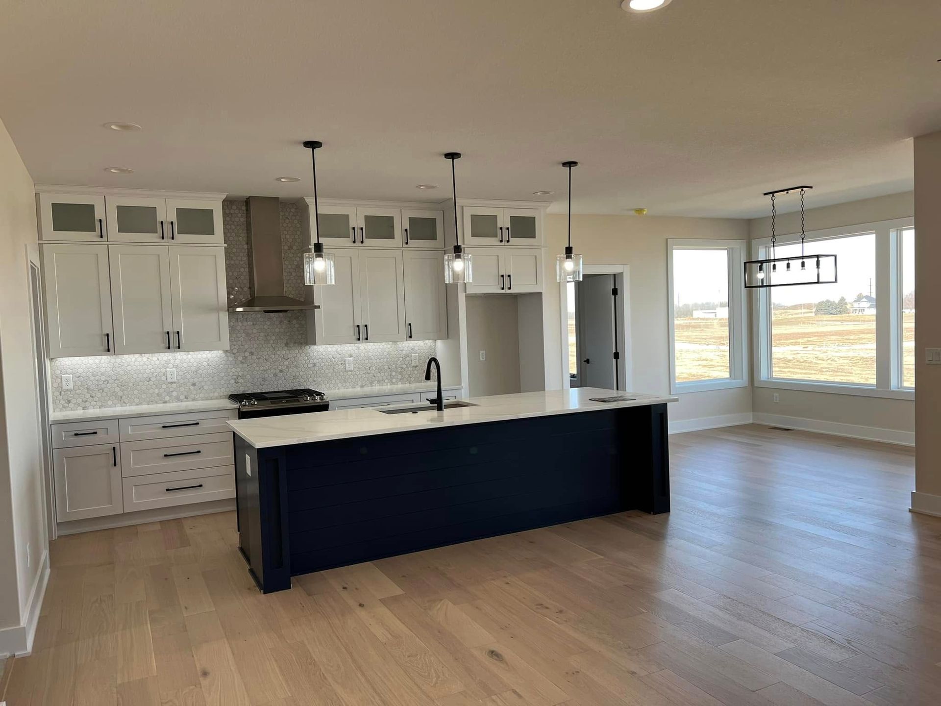 A kitchen with a large island in the middle of the room.