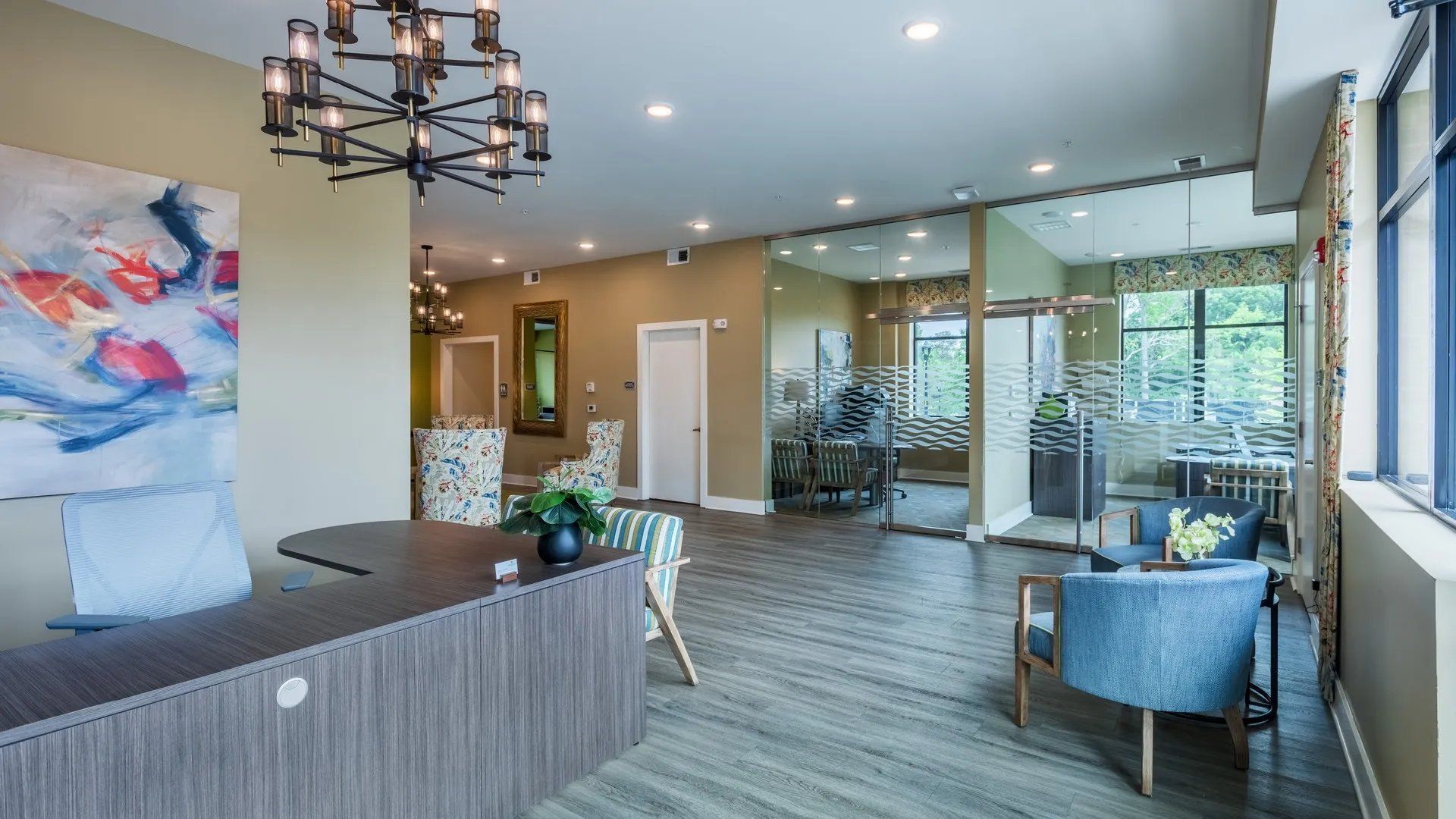 Interior view of a modern community lounge area with seating and artwork. Our Wexhaw, NC apartments provide the best in luxury living in downtown Waxhaw. Ready to make our community your home? Contact Waxhaw Mills today to learn more and schedule your personalized tour! 