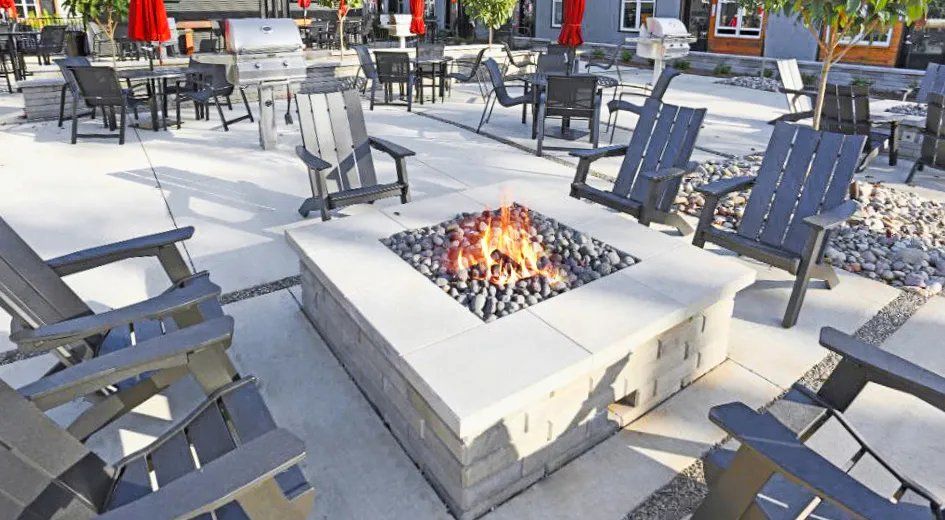 Outdoor communal fire pit surrounded by seating. Our Wexhaw, NC apartments provide the best in luxury living in downtown Waxhaw. Ready to make our community your home? Contact Waxhaw Mills today to learn more and schedule your personalized tour!