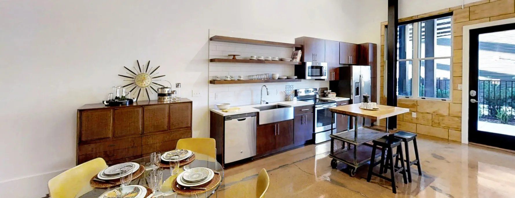 Modern kitchen with wood cabinets and stainless steel appliances. Interested in learning more about our 1, 2, and 3-bedroom apartments in Waxhaw, NC? Contact us today to schedule your tour!