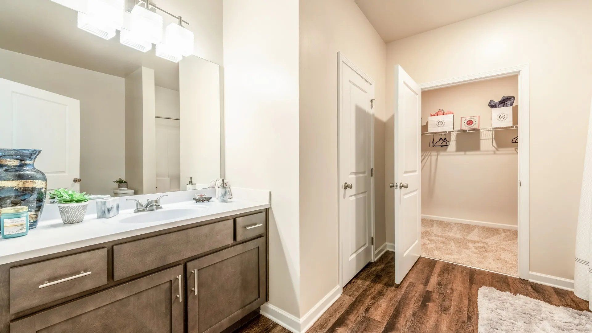 Modern bathroom with a mirror and closet. Interested in learning more about our 1, 2, and 3-bedroom apartments in Waxhaw, NC? Contact us today to schedule your tour!