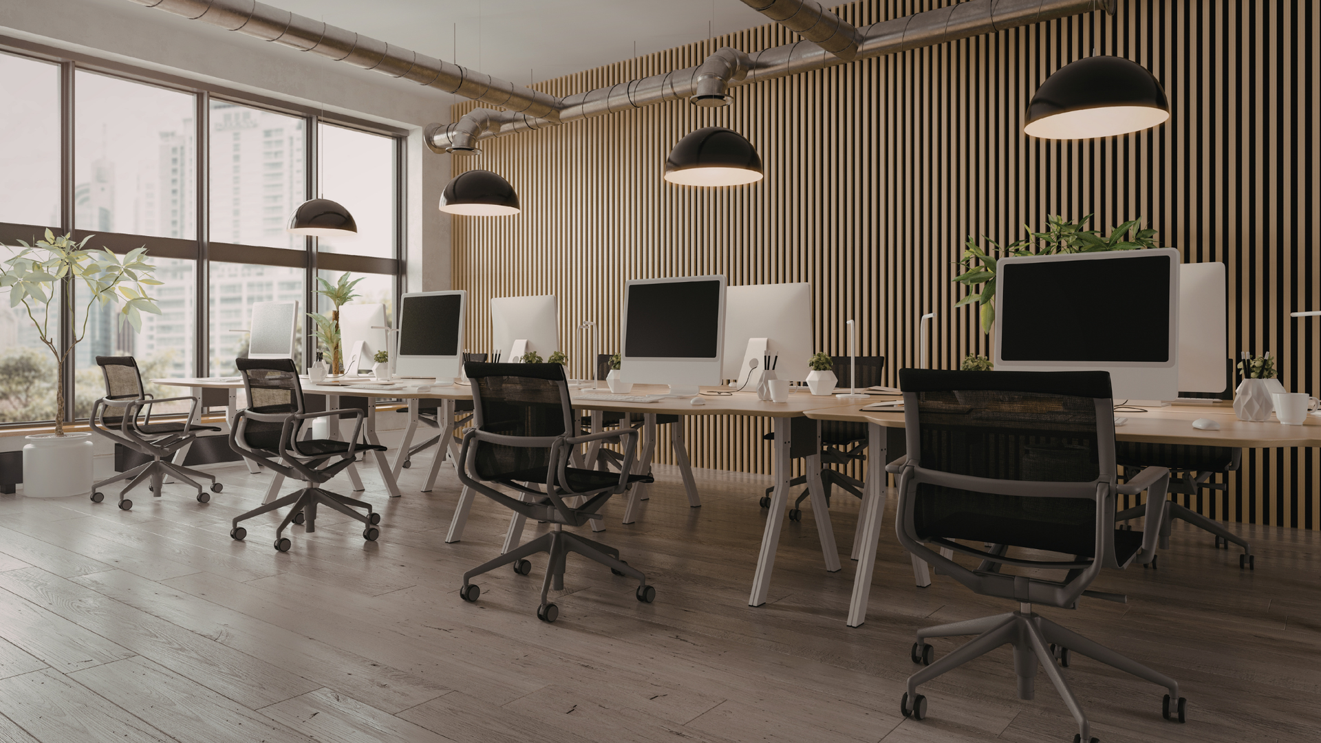 Modern open office with desks, computer monitors, swivel chairs, and large windows with blinds