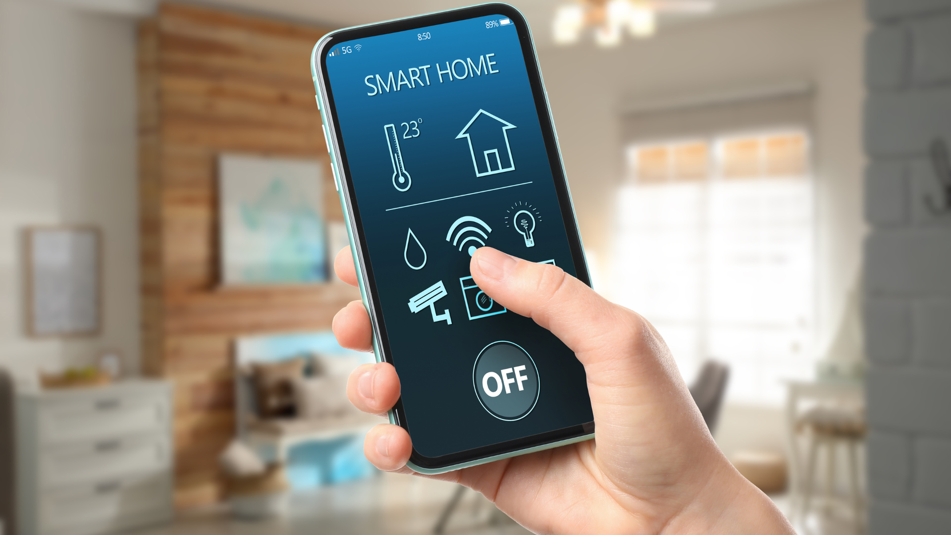 Hand holding a smartphone showing a home automation app with smart home controls.