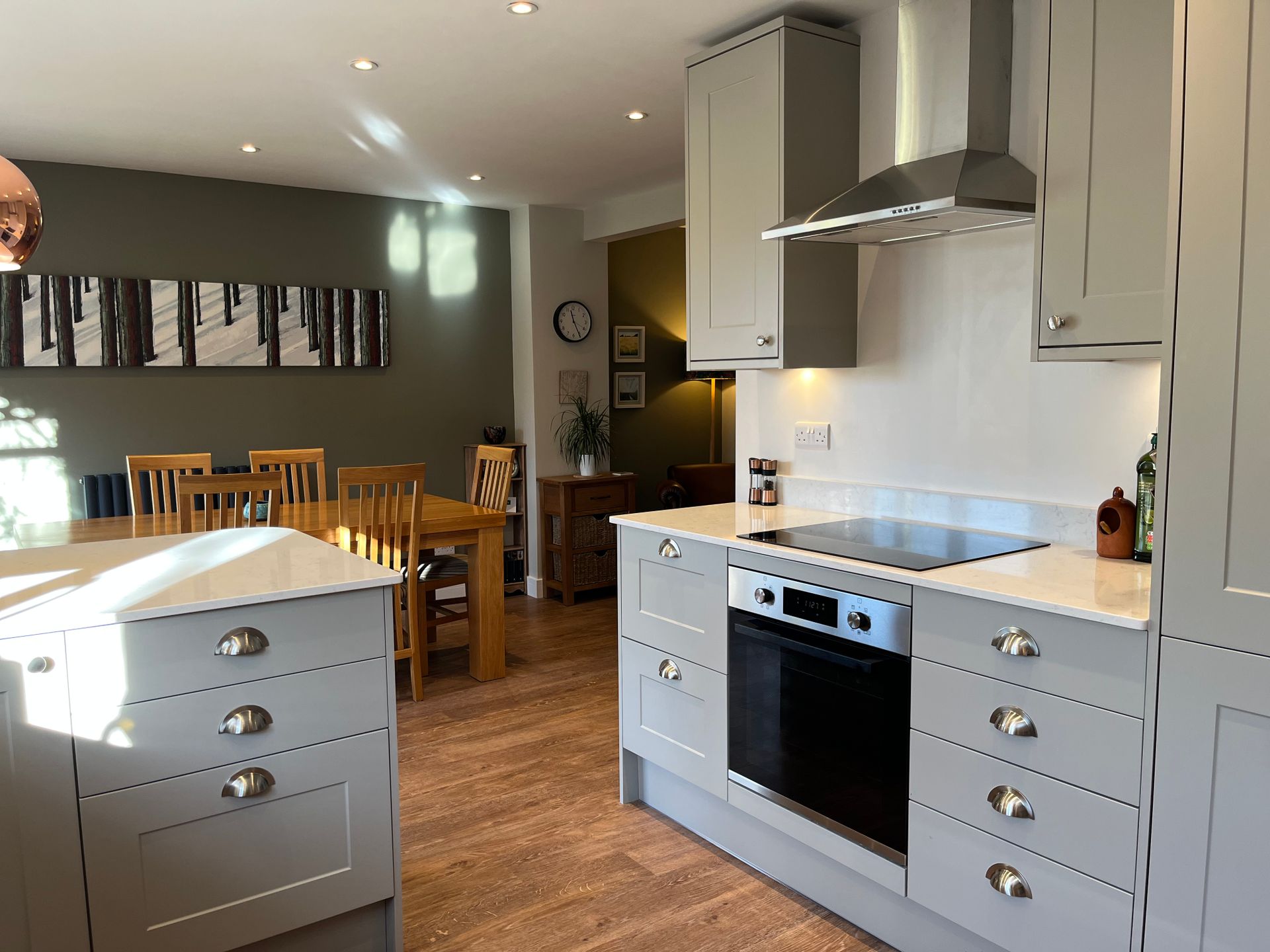 A kitchen with stainless steel appliances and white cabinets