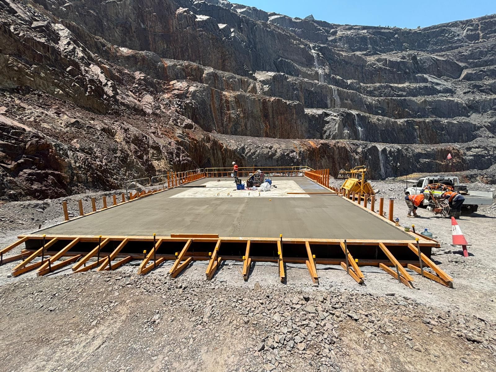 Concrete platform under construction in a quarry; workers, wooden framework, and machinery visible.  - Lamont Civil, QLD
