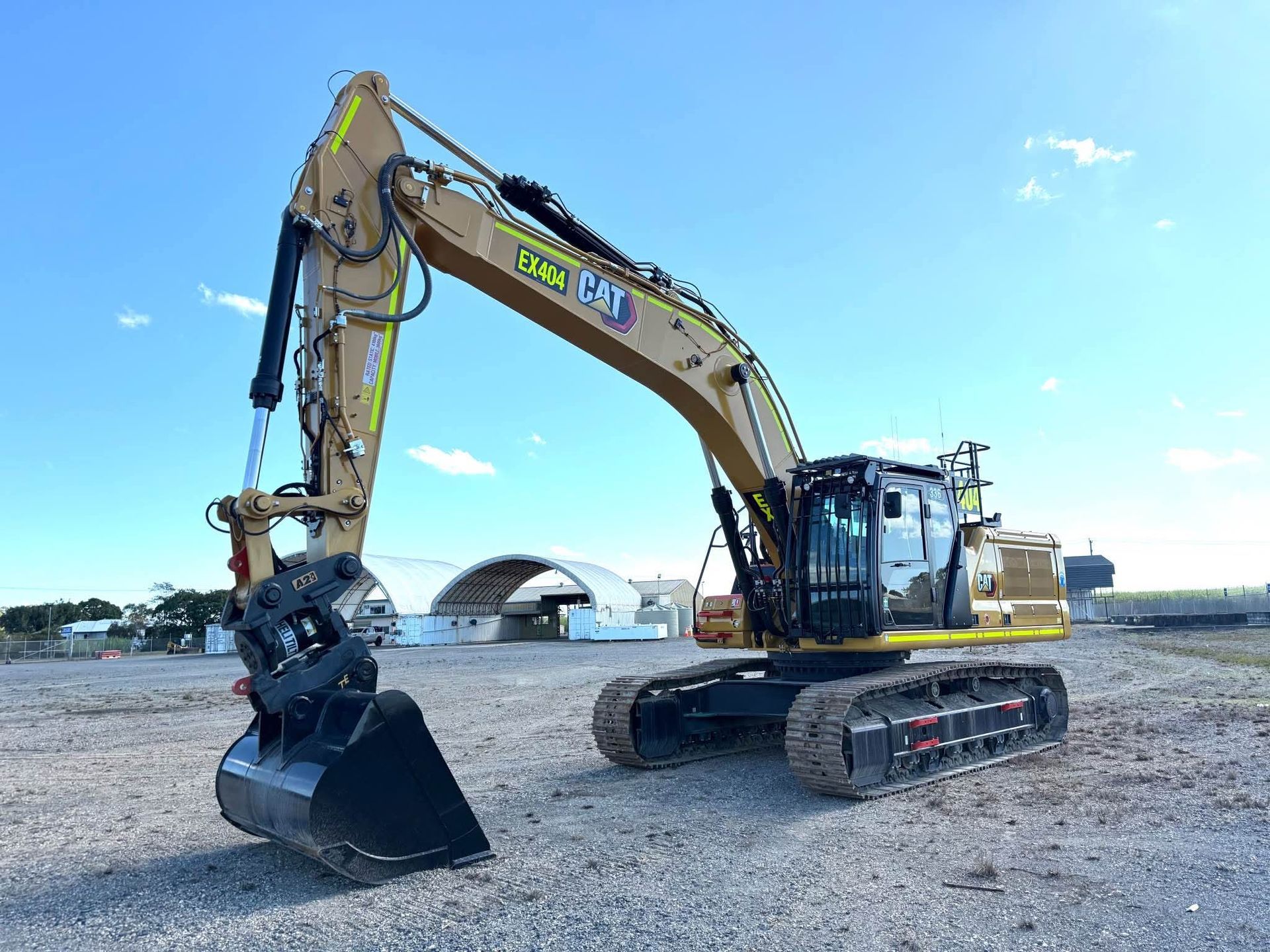 Yellow Cat Soil Compactor On A Dirt Surface, With A Cab And Large Rear Tire — Lamont Civil Services Pty Ltd In Townview, QLD