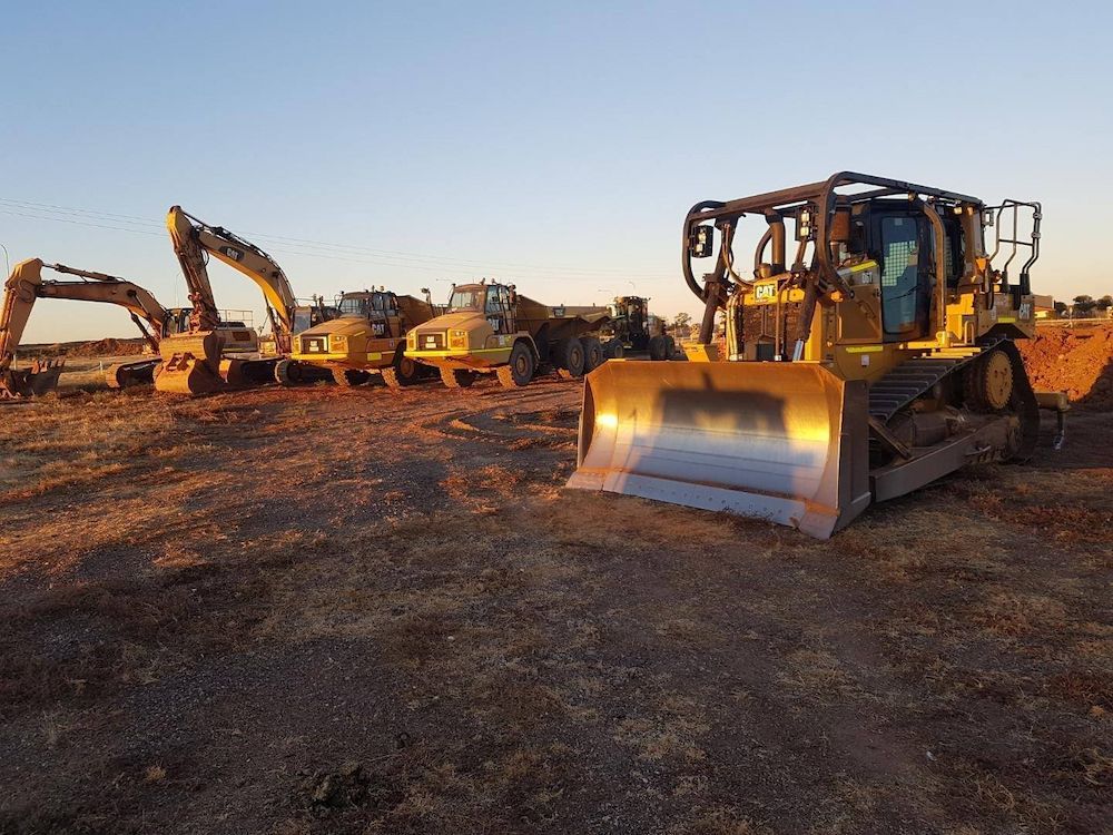 Yellow Construction Equipment Parked at a Worksite at Dusk — Lamont Civil Services Pty Ltd In Mount Isa, QLD
