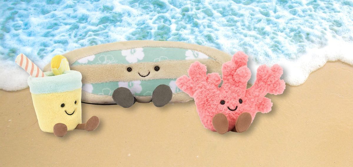 Latitude Buddies plush mascots with suitcases, symbolizing playful family travel