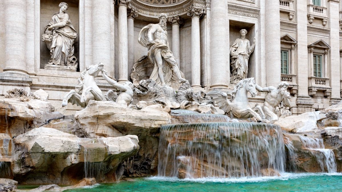 Trevi Fountain, Rome; Neptune statue, flowing water, classical architecture.