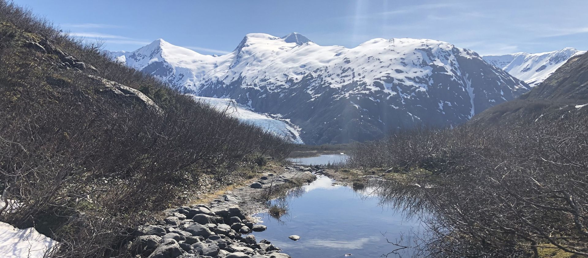 Latitude Buddy plush at Portage Glacier — scenic Alaska travel photo near Anchorage.