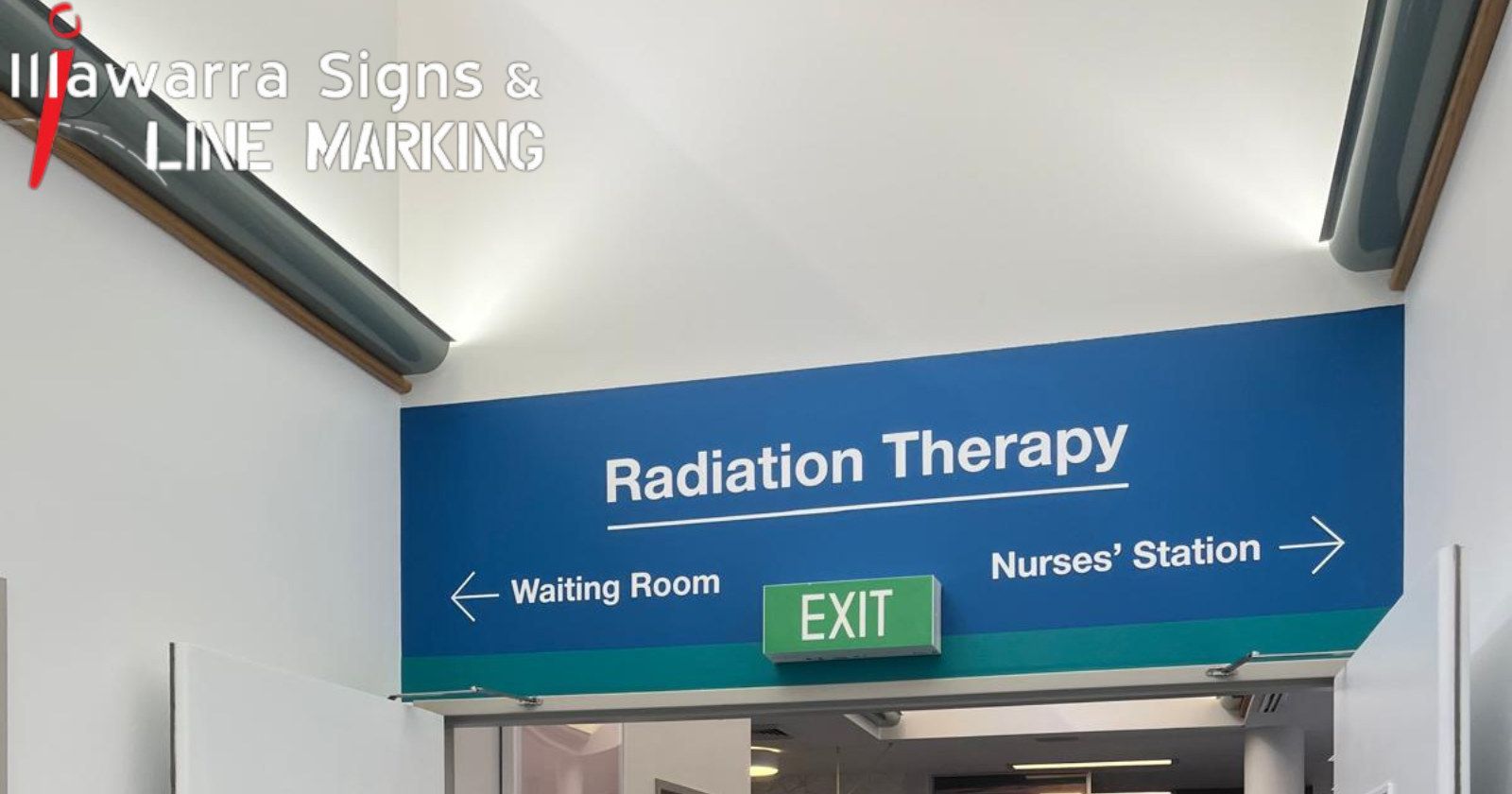 Blue overhead wayfinding sign to Radiation Therapy in a hospital