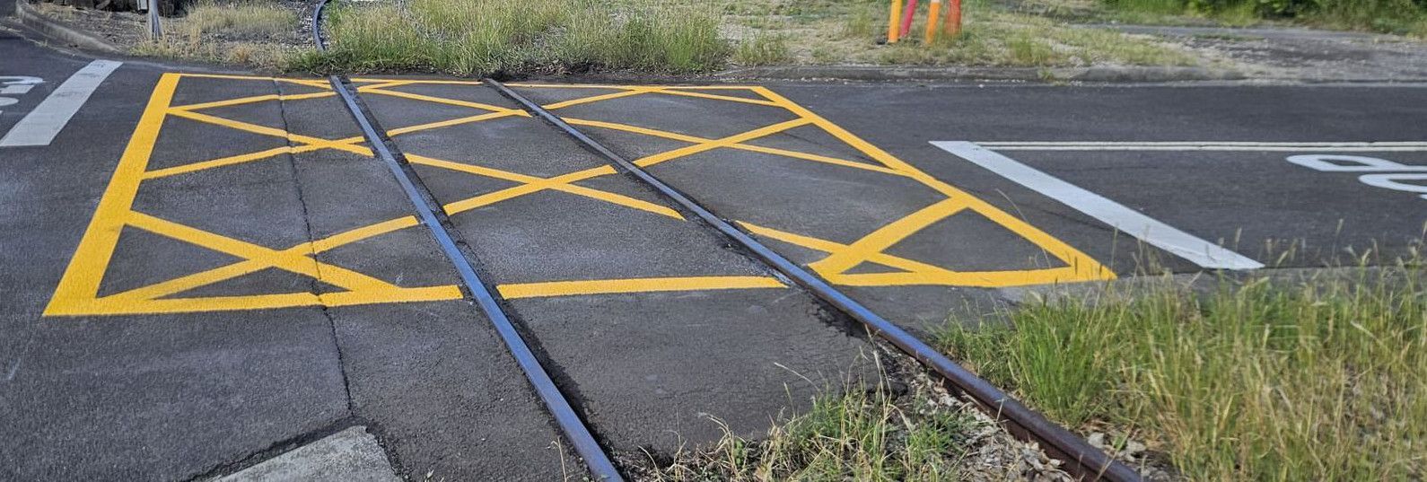 Yellow keep clear box marked across a rail crossing at a steelworks