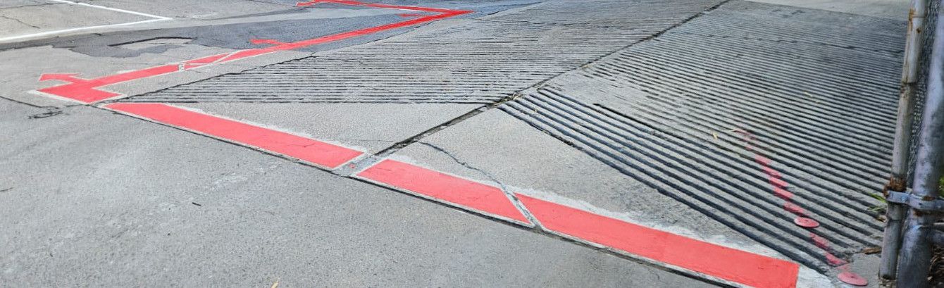 Red exclusion lines and arrows across a concrete plant yard