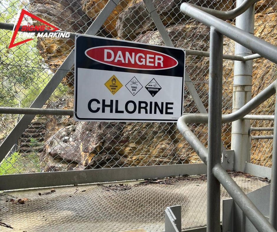 Danger chlorine sign on a walkway rail at a water site