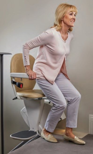 Woman Standing From Her Stair Lift Chair Woman Standing From Her Stair Lift Chair