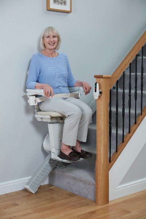 Woman Riding on a Handicare 1100 Straight Stair Lift