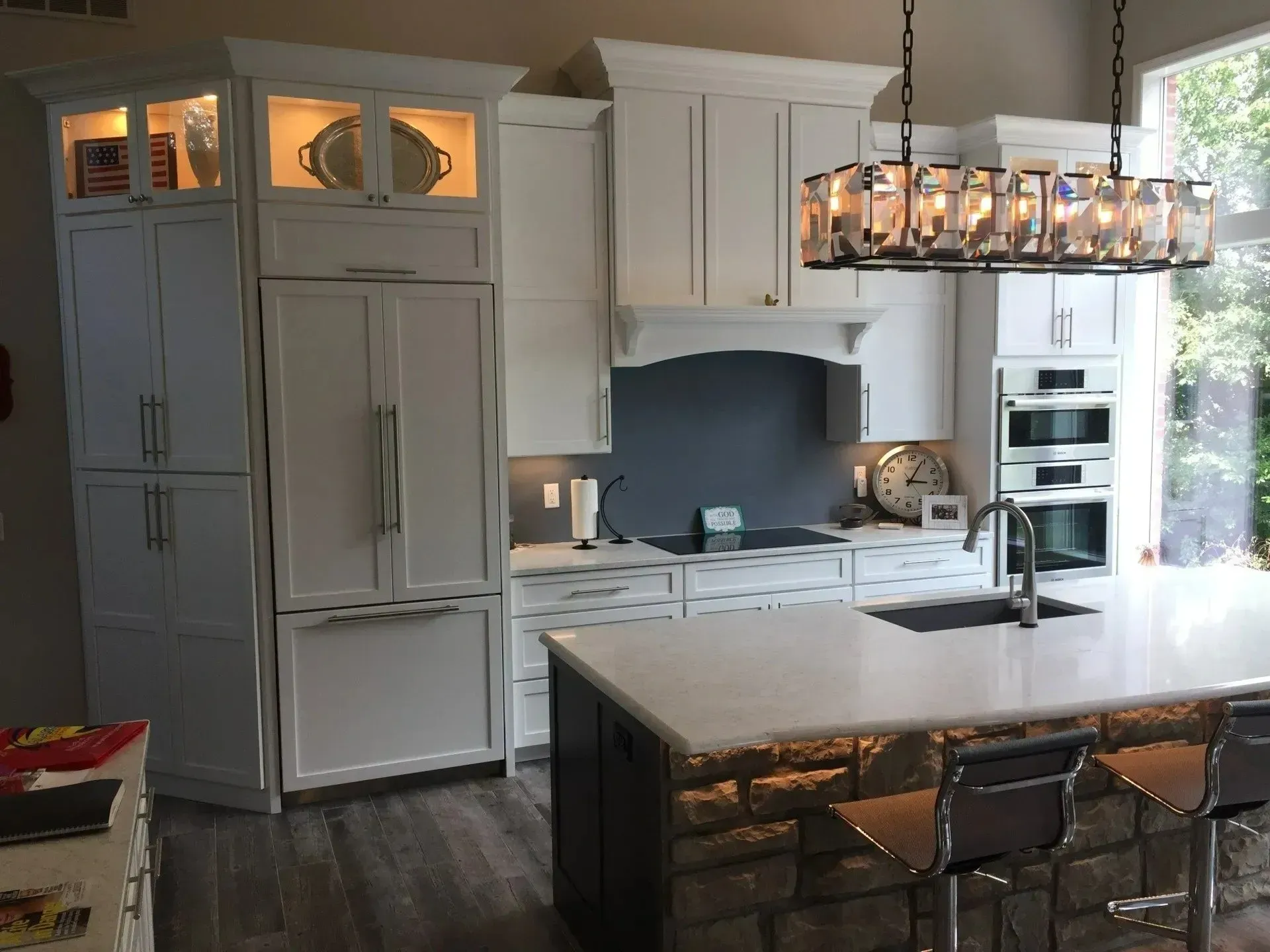 A kitchen with white cabinets and a large island