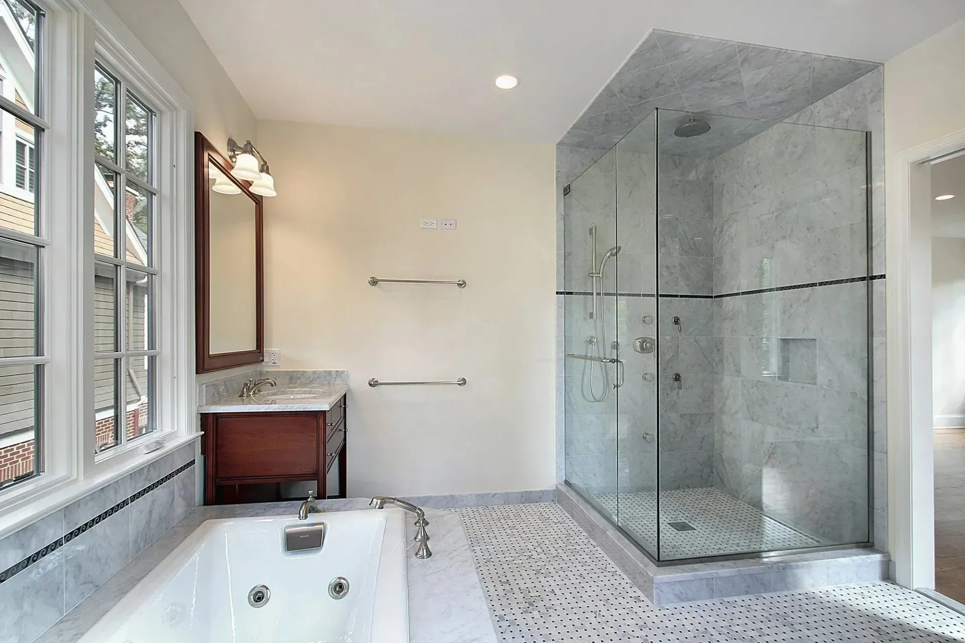 A bathroom with a tub and a walk in shower