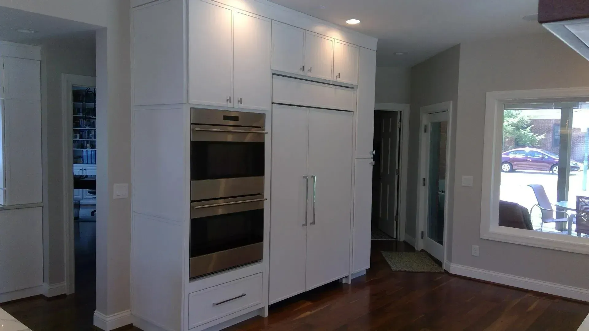 A kitchen with white cabinets and stainless steel appliances.