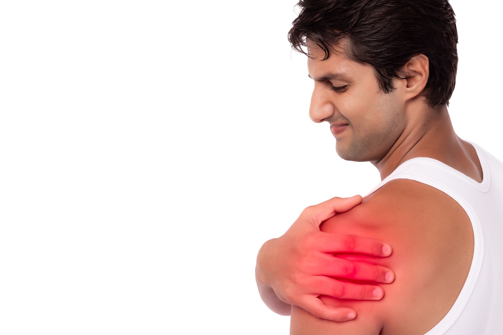 A man is holding his shoulder in pain.
