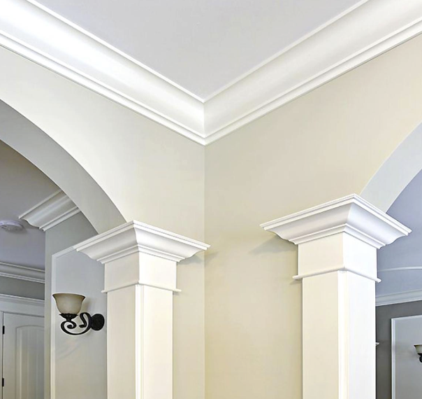 Cream-colored room corner with decorative white molding and columns.
