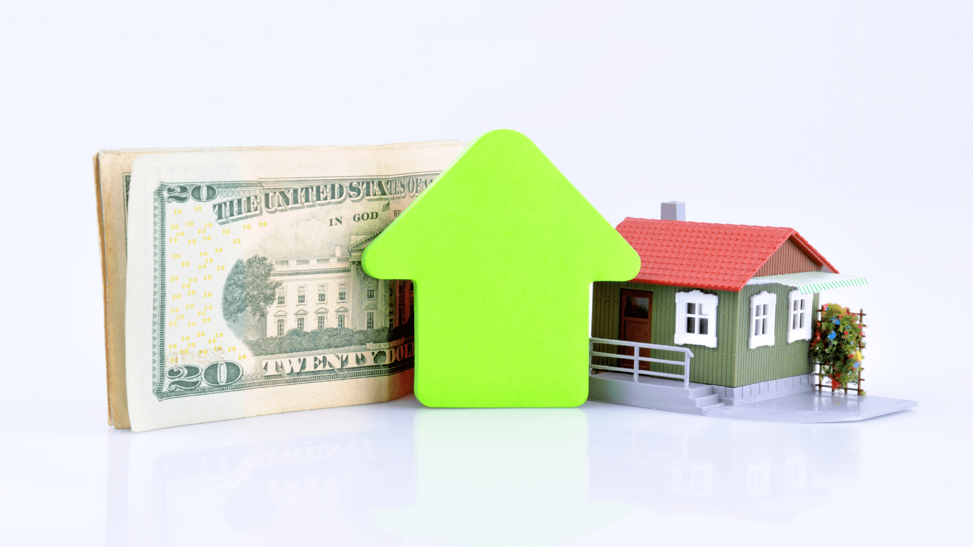 Stack of money and a house with a large arrow pointing up.