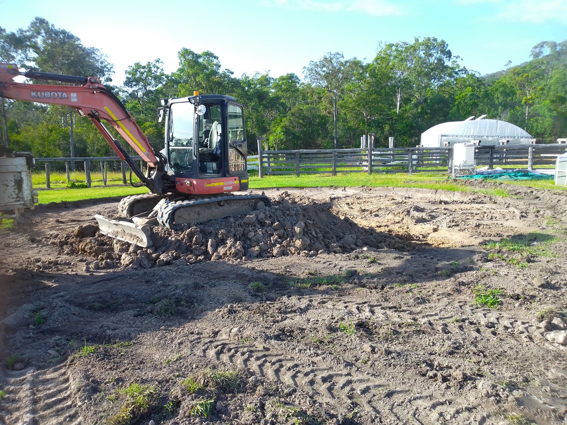 A Digger Is Sitting On A Pile Of Dirt In A Field — Ant's Earthworks In North Deep Creek, QLD 