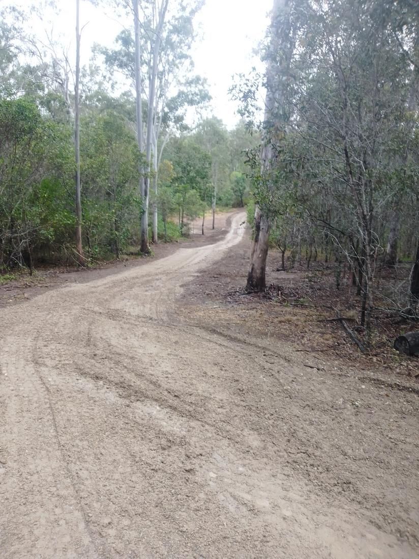 A Dirt Road Going Through A Forest With Trees On Both Sides — Ant's Earthworks In North Deep Creek, QLD 