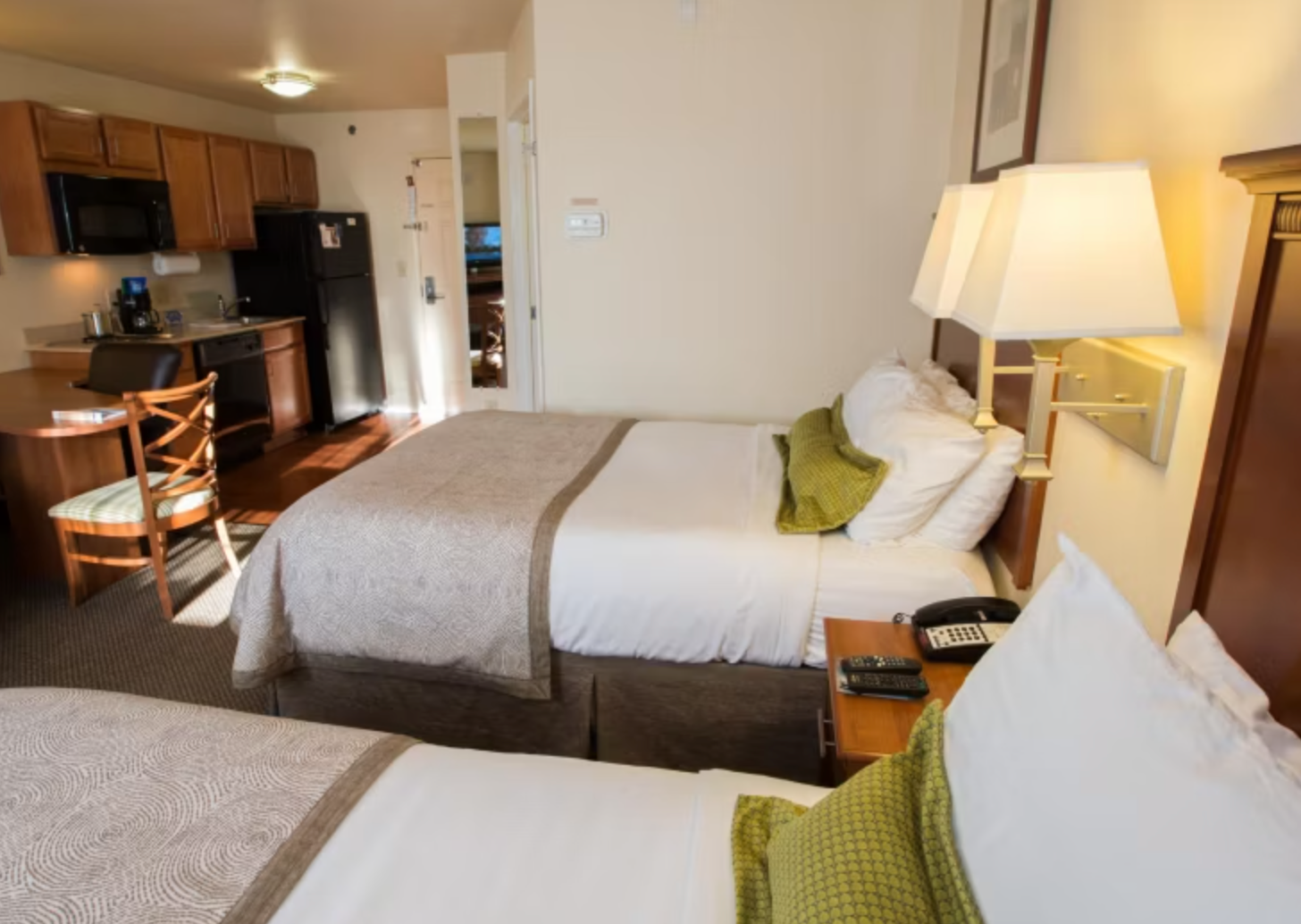 King guest room with plush bedding and flat-screen TV