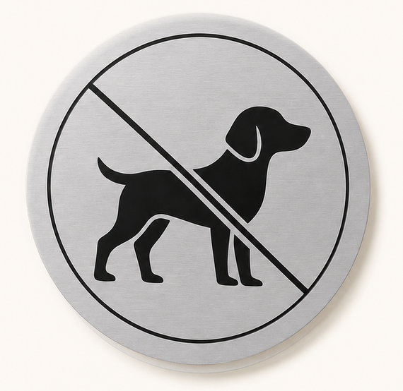 No dogs allowed sign with black dog silhouette crossed out on a silver circle