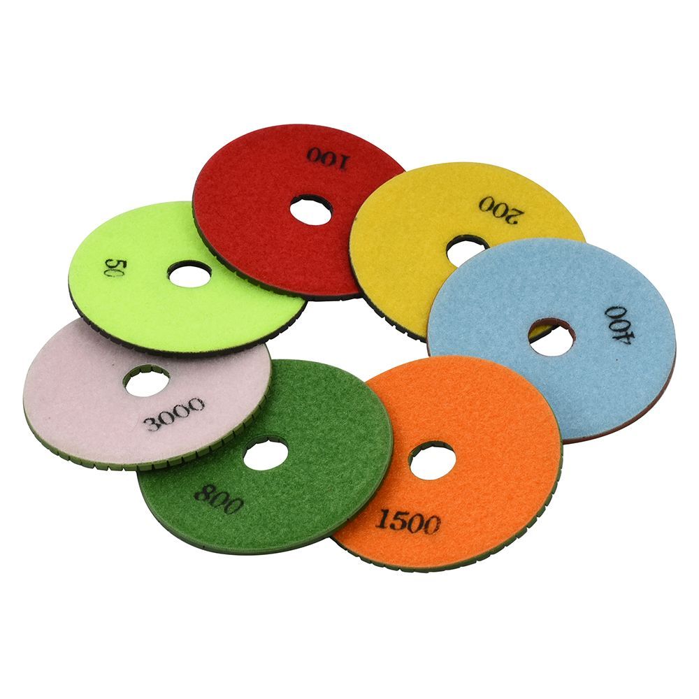 Colorful numbered sanding discs stacked in a fan shape on a white background