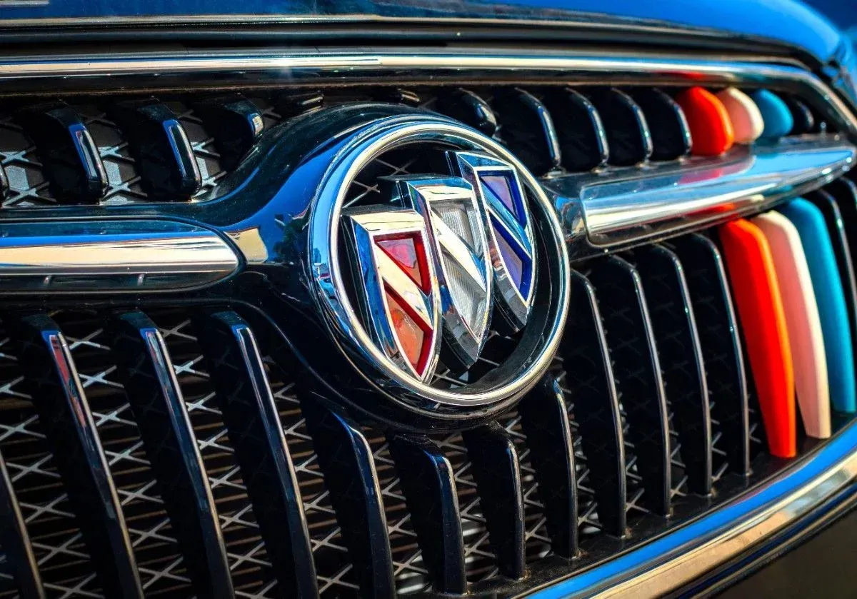 Close-up of a Buick grille and emblem with chrome trim and red-blue accents