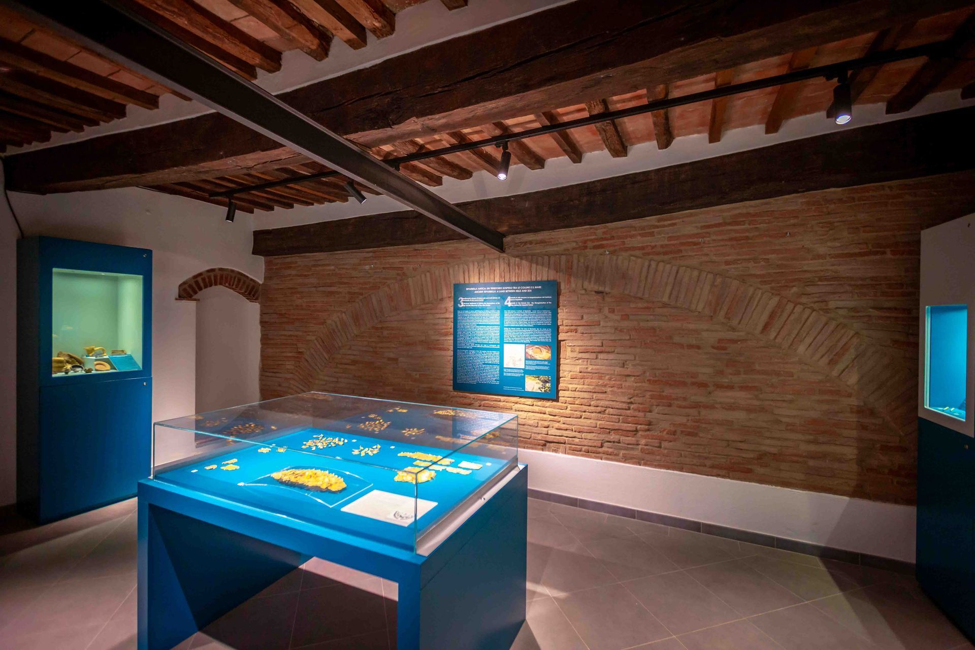 One of the rooms along the route, with cases, display cabinets and historic walls