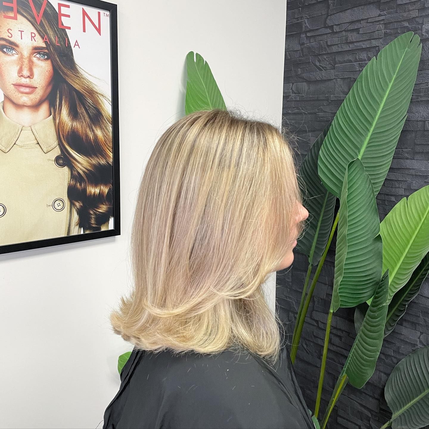A Woman With Long Hair and Bangs is Wearing a Black Shirt — Blackwell Hair In Woree, QLD