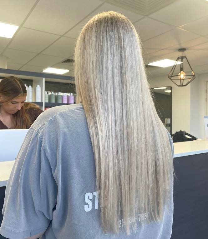 A Woman With Long Hair and Bangs is Wearing a Black Shirt — Blackwell Hair In Woree, QLD