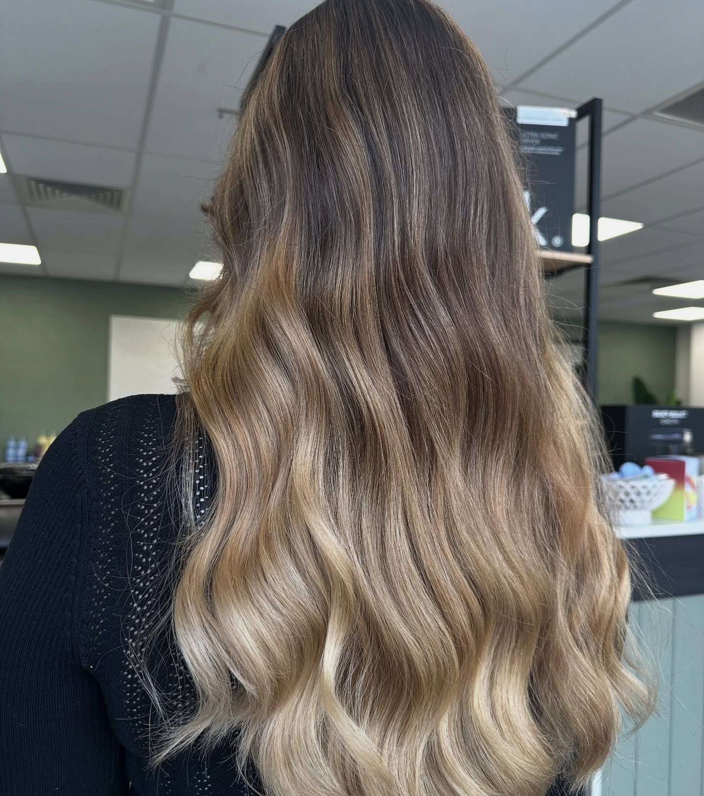 Wavy Brown Hair With Blonde Balayage, Viewed From The Back In A Salon Setting — Blackwell Hair In Woree, QLD