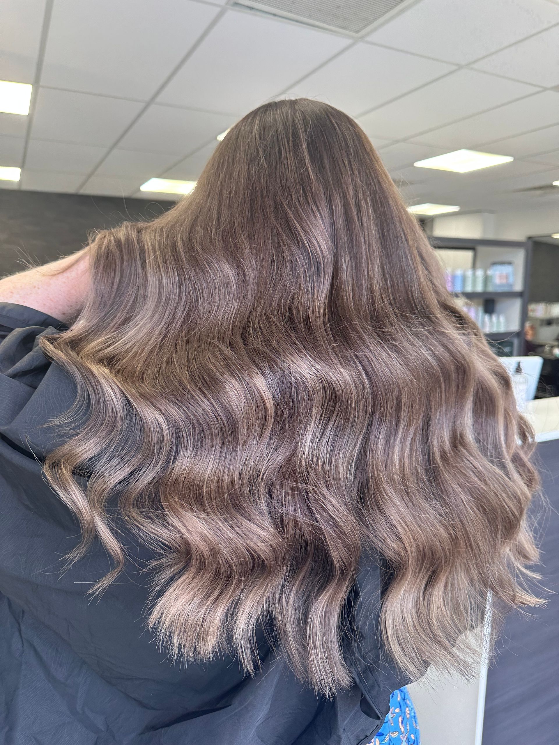 Person With Long, Wavy Brown Hair Seen From Behind In A Salon — Blackwell Hair In Woree, QLD