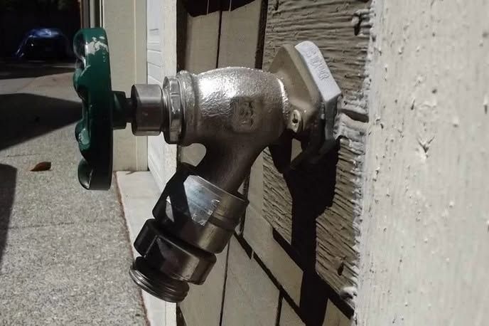 Outdoor faucet with a hose connection mounted on a wall