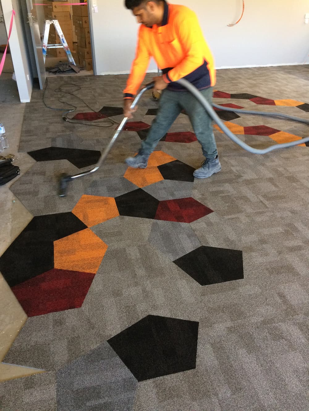 Person Vacuuming Floor - Custom Design Flooring in Alice Springs, NT