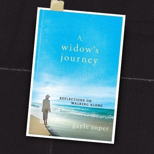 Book cover of “A Widow’s Journey” by Gayle Roper, showing a woman walking along a beach under a blue sky.